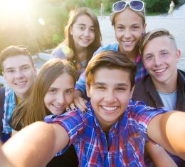 group of teenagers in the park do selfie